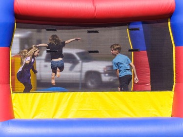 Children enjoy a bouncy castle at the Lions Club rodeo in Cochrane on Monday, Sept. 5, 2022.