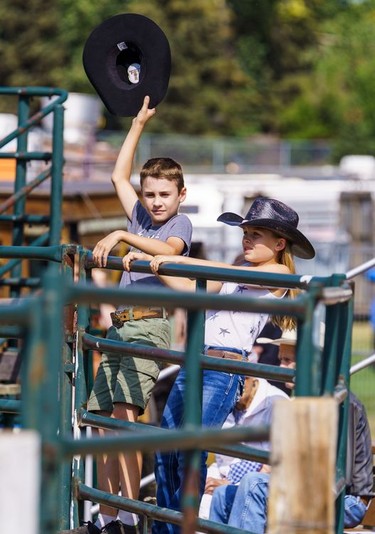 A boy waves his cowboy hat at the Lions Club rodeo in Cochrane on Monday, Sept. 5, 2022.