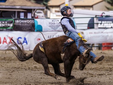 A young boy barely hangs on to a horse at the Lions Club rodeo in Cochrane on Monday, Sept. 5, 2022.