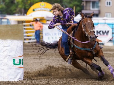 A rider makes a sharp turn during barrel racing at the Lions Club rodeo in Cochrane on Monday, Sept. 5, 2022.