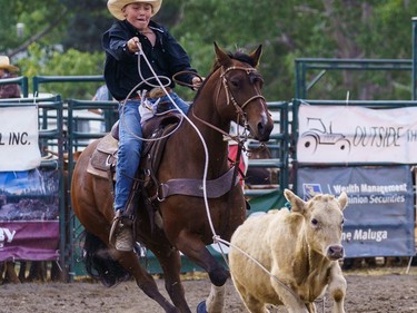 A rider tries to rope a calf at the Lions Club rodeo in Cochrane on Monday, Sept. 5, 2022.