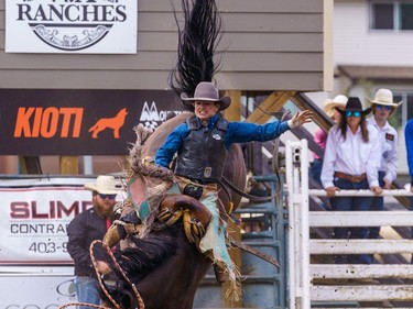 A boy hangs on to his horse during saddle bronc riding at the Lions Club rodeo in Cochrane on Monday, Sept. 5, 2022.