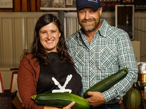 Ray and Todd Anne Simmer pose with zucchini at The Local Yokel year-round market in Cochrane on Friday, Sept. 9, 2022.