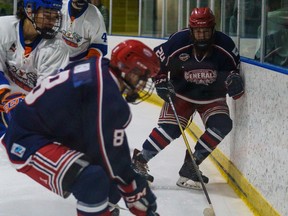 Cochrane Generals defender Evan Black, right, battles his way toward the puck against the High River Flyers at the Cochrane Arena on Saturday, Sept. 24, 2022. The Generals beat the Flyers 7-1 in Heritage Junior Hockey League Action.