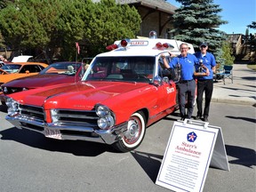 Dr. Tim Prieur and paramedic Ron McManus stand next to the 1965 Pontiac Starr's Ambulance. Photo by Dana Zielke