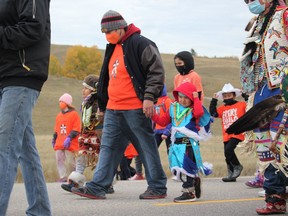 Emmanuel, Roger and Darius make their way down Highway 1A through the Stoney Nakoda First Nations as part of a September 30, 2021 ceremony to mark National Day for Truth and Reconciliation/Orange Shirt Day. Patrick Gibson/Cochrane Times ORG XMIT: POS2110032241005089