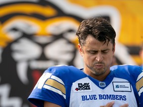 Winnipeg Blue Bombers quarterback Zach Collaros (8) pauses during a moment of silence for Queen Elizabeth II prior to CFL football game action against the Hamilton Tiger Cats in Hamilton, Ont. on Saturday, Sept. 17, 2022.