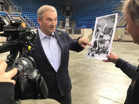 Former Soviet star goaltender Vladislav Tretiak, filmed by Ice-Breaker director/co-producer Robbie Hart in Moscow's Luzhniki Palace of Sports, looks at a photo of the famous Paul Henderson goal in Game 8 of the 1972 Summit Series. Adobe Productions International