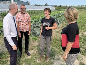 Ayla Fenton of Loving Spoonful, second from right, shares a laugh with, from left, Kingston Mayor Bryan Paterson, St. Lawrence College president and chief executive officer Glenn Vollebregt and Tracey Snow, the city's manager of rural economic and community development, on Friday.