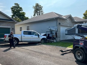 Kingston Police have charged a local 21-year-old after a truck was driven into the side of an east-end house on Saturday morning.