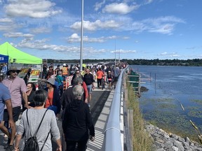Pedestrians make their way across the new Cataraqui River bridge for the "Walk, Ride & Roll — Third Crossing Preview" on Saturday.