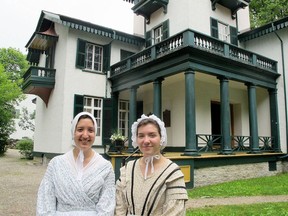 Costumed Bellevue House tour guides in front of historic Bellevue House on Centre Street in Kingston.