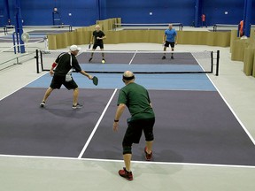 Pickleball players Mike Shkimba, front left, and Terry Fitzpatrick play against Ron Heidebrecht, rear left, and Gunther Mally in a men's ladder match at the Kingston Pickleball Club at 1150 Gardiners Rd. in Kingston on Thursday.