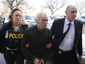 Police escort Michael Wentworth, 65, of Kingston into court for a bail hearing in Kingston, following his arrest on Friday, Feb. 15, 2019.