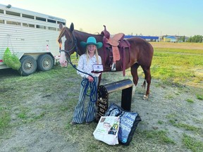 Alianna Cox and her horse, Levi, pose with the championship belt buckle and saddle. (Supplied)