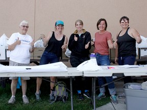 Volunteers Faith Zacher, Alecia Williams, Hailey Smith, Rhonda Oczkowski, and Celine Rickard (left to right) ran the MoonShadow Run 2022 sign-in booth behind the Pincher Creek Swimming Pool on Main Street on Sept. 10.