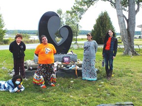 Photo by LESLEY KNIBBS
Shealyn Spanish, R.J. Stoneypoint, Saleena Sutton, Myra Southwind and Elizabeth Cassidy at the monument for residential school children in Spanish.