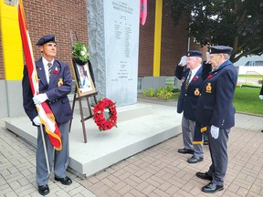 Photo by Jacqueline Rivet
Ron Arbour (Colour Guard), Gary MacPherson (president), and past president Jack Fraser saluting by the wreath and portrait of Queen Elizabeth II. For the story, see page 2.