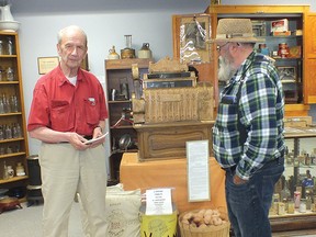 Photo by LESLIE KNIBBS
Massey resident Charlie Smith (right) presented John Sadowski with a book of his poetry at the Sadowski display in the Massey and Area Museum.