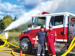 Photo by Jacqueline Rivet
Jim Adams from ITW Inc. and Henry Girard, Espanola volunteer firefighter, test the capacity of the pump on one of the fire trucks.