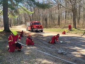 Photo supplied
Members of the Sables Spanish River Fire Department during a training session rolling out the hose.