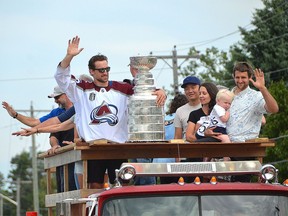 Colorado Avalanche player Kurtis MacDermid and the Stanley Cup ride down Lakeshore Boulevard in Sauble Beach on the back of a fire truck on Aug. 29.