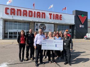 Canadian Tire Pembroke owner operators Ray and Barb Pilon recently made a $10,000 donation to the Pembroke Regional Hospital Foundation's Black and White Gala as a gift of humanity. Taking part in the donation is, in front from left, Ray and Barb Pilon and Roger Martin, executive director of the hospital foundation.