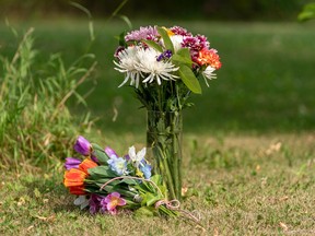 Flowers are placed in front of the home of a victim who has been identified by residents as Wes Petterson in Weldon, Sask., on Monday, September 5, 2022. Saskatchewan RCMP say arrest warrants have been issued for two suspects in a deadly stabbing rampage who remain at large.