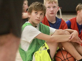 Colin Priestap, left, and Evan Abercrombie listen to instructions during the 37th Hoop Camp at Stratford District Secondary School this week.