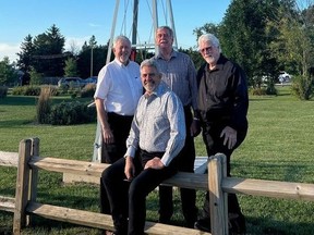 Bryan Beattie, left, Gerhard Eilers, Ed Fluter and Alex Mustakas (seated) pose by a windmill recently installed at the Huron Country Playhouse in Grand Bend. (Submitted)