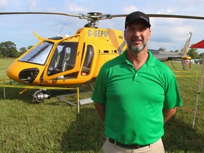 Pilot Paul Grech stands next to the helicopter he flies for Enbridge.  It was on display at Saturday's car show hosted by the company in Sarnia to raise money for the United Way of Sarnia-Lambton.