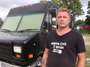 Chris Tripp stands next to the food truck he owns with his mother in Petrolia.  A noose tied around a Pride flag was left at the truck while it was parked overnight at the Petrolia and Enniskillen Fall Fairgrounds.