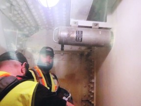 A screenshot of a video shown to attendees of bridge workers removing the time capsule from the bridge span's tub girder.  (Tyler Kula/ The Observer)