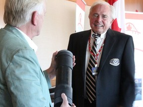 Seaway Kiwanis member Bob Bettridge looks on as the club's Frank Stancic opens a container from a 25-year-old time capsule removed from the Blue Water Bridge Tuesday. The time capsule is being returned for another 25 years, officials said. (Tyler Kula/ The Observer)