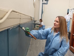 Krystyna Kahnert, with Lambton College, helps out with painting at the Boys and Girls Club in Sarnia during the United Way Day of Caring.