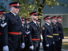 From left, staff Sgt. Ivan Skinn, acting Insp. Michael Van Sickle, acting deputy chief Peter Murphy, Chief Derek Davis and Const. Mark David lead a group of Sarnia police officers during Wednesday's funeral service for slain Toronto police Const. Andrew Hong. (Sarnia police)
