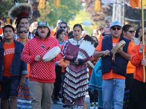 Drummers Giniw Paradis, left, and Jordan Williams White Eye take part on Friday's march through Sarnia's downtown as part of observances in Sarnia for the National Day for Truth and Reconciliation.
