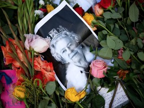 A photograph of Queen Elizabeth II lays among the flowers at a memorial site in Green Park near Buckingham Palace following the death of the queen on Sept. 11, 2022 in London, U.K. The City of Pembroke, Ont. is closing its offices on Monday for the National Day of Mourning for the Queen's funeral. PHOTO BY CHIP SOMODEVILLA /Getty Images