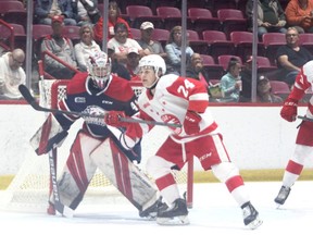 Soo Greyhounds forward Justin Cloutier skates in front of Saginaw Spirit goaltender Brett Fullerton during the first period of OHL pre-season action at the GFL Memorial Gardens on Saturday night. The Hounds picked up a 3-1 victory over the Spirit.