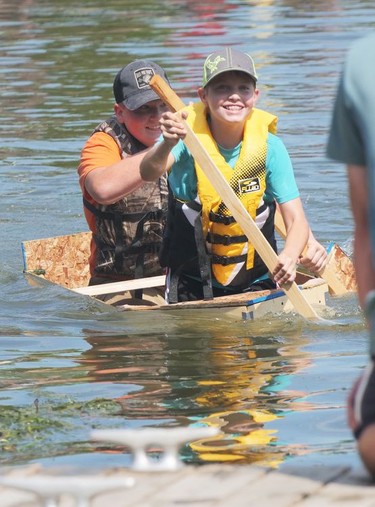 Jack Strobridge (in the bow) and Kyle Boughner from St. Williams were taking on water as they reached the finish line Saturday during the Build a Boat competition at Bayfest in Port Rowan. CHRIS ABBOTT