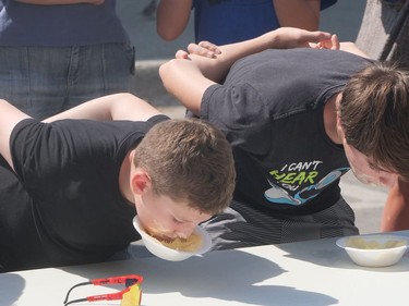 Talan Long (left) and Luke Bonin compete in Saturday's ice cream eating competition at Bayfest. CHRIS ABBOTT