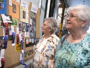 Jeanne Robillard (left) of Walsingham and Sharon Beausaert of Port Rowan enjoy the photography exhibits Wednesday at the Langton Fair.