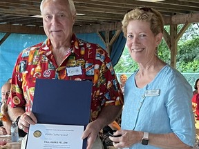 Keith Catherwood, left, of Simcoe was presented recently with a Paul Harris Fellow award by Joanne Kiefer on behalf of the Rotary Club of Norfolk Sunrise. CONTRIBUTED PHOTO
