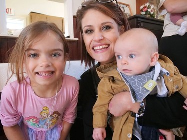 Five-month-old Atlas Giesbrecht, with his mom Heidi and big sister Averleigh, won second place in the Houghton Agricultural Fair baby contest Thursday, Sept. 29 in Fairground. CHRIS ABBOTT