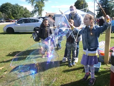 Summer Peters from Frogmore was having fun making bubbles at the Houghton Agricultural Fair Thursday in Fairground. CHRIS ABBOTT