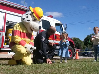 Avyn and Nova Wall met Sparky the fire dog mascot,  and firefighter Randy Jackson from Norfolk County Fire Station 8 (Faiground) Thursday, Sept. 29 at the Houghton Agricultural Fair. CHRIS ABBOTT