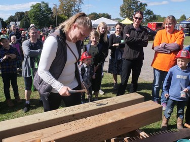 Nancy Friesen, from Kinglake, tests her nail-driving skills Thursday, Sept. 29 at the Houghton Agricultural Fair. CHRIS ABBOTT