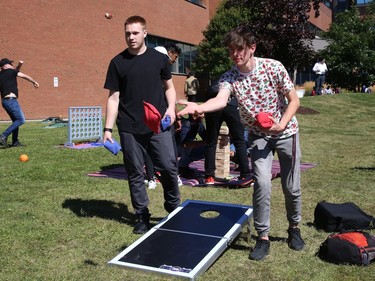 Students Cohen Desjardins, left, and Owen Parsons play a game of bean bag toss at the Meet and Greet Carnival at Cambrian College in Sudbury, Ont. on Wednesday September 7, 2022. The event was held as part of Cambrian CollegeÕs Orientation Week activities. The carnival featured entertainers, free food, snacks, popcorn, games and student services. John Lappa/Sudbury Star/Postmedia Network
