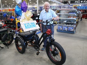 Joe (Joachim) Doucet checks out his new e-trike that was presented to him at Princess Auto in Sudbury, Ont. on Thursday September 8, 2022. A GoFundMe campaign was spearheaded by Chantelle Gorham to purchase the e-trike after Doucet's e-trike was stolen. The 90-year-old resident of New Sudbury had his nearly brand-new vehicle snatched from outside Princess Auto on Aug. 20. Gorham said in an email that Manitoulin Transport delivered the bike from "a couple in Ottawa who wanted Joe to have a bike more than they wanted to have their asking price for it." She said, "This put our target within reach, and made this mission totally attainable." Gorham along with campaign supporters from Princess Auto, Manitoulin Transport and community members were on hand for the presentation. John Lappa/Sudbury Star/Postmedia Network