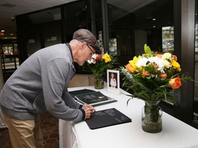 Michael Neville signs a book of condolences for Queen Elizabeth II at Tom Davies Square in Sudbury, Ont. on Tuesday September 13, 2022. The book will be available for signing in the main foyer of Tom Davies Square during regular business hours until 4:30 p.m. on September 23, 2022. A release from the city said, "All messages received will be sent to the Royal Family on behalf of the community. Residents can also sign the national online book of condolences at www.canada.ca/en/canadian-heritage/commemoration-her-majesty-the-queen/book.html." John Lappa/Sudbury Star/Postmedia Network